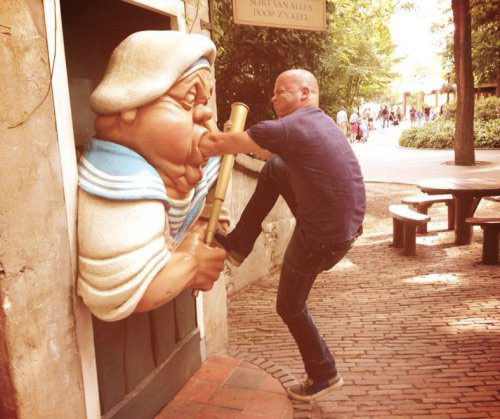 man insert hand on statue mouth